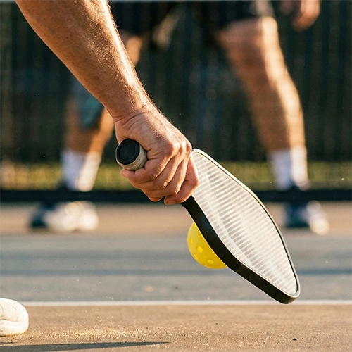 Player executing a strategic pickleball dink shot near the net