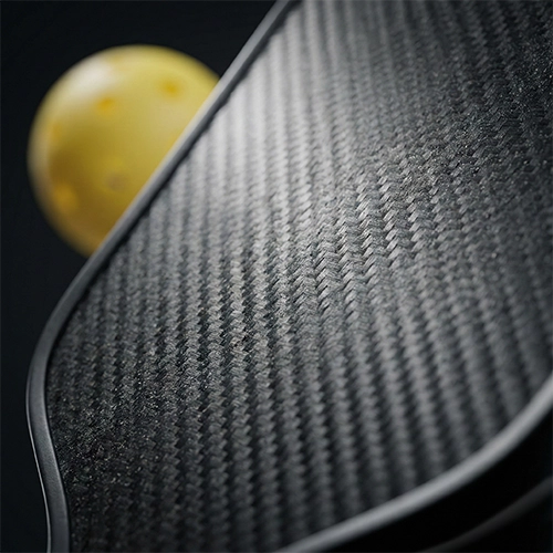 Close up of a textured carbon fiber pickleball paddle face